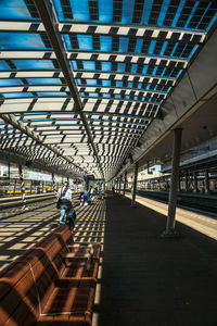 People walking on railroad station platform