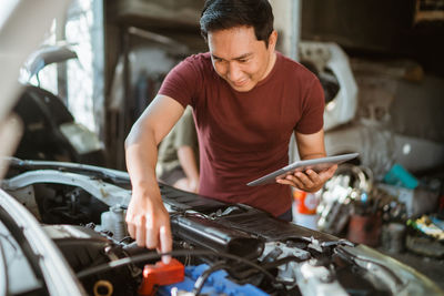 Side view of man working at workshop