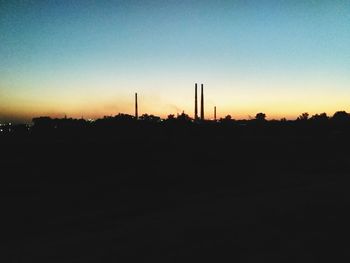 Silhouette landscape against clear sky during sunset