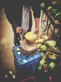 Close-up of man with fruits in basket at market stall