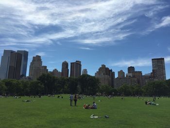 People relaxing in front of modern building