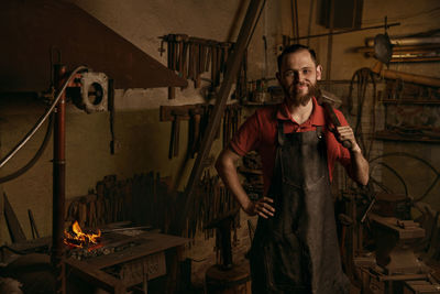 Portrait of man standing against wall