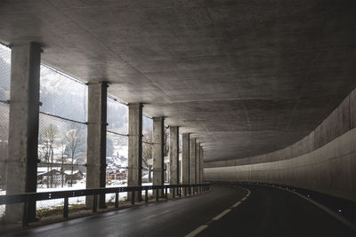 Empty road along buildings