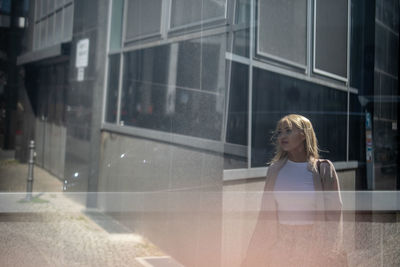 Multiple image of woman walking on footpath in city