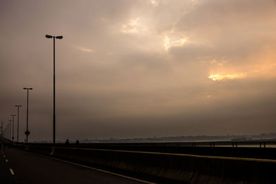 Street against sky during sunset