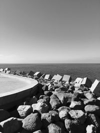 Rocky shore and sea against sky