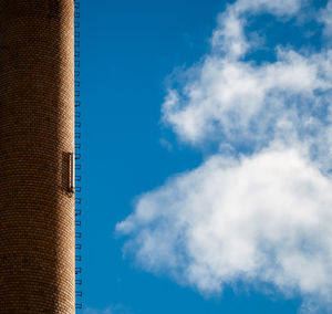 Low angle view of modern building against blue sky