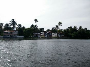 Scenic view of river with houses in background