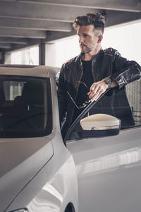 Portrait of young man sitting in car