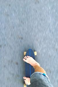 Low section of man standing on road