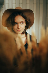 Portrait of young woman wearing hat