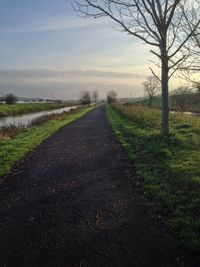 Empty road passing through field