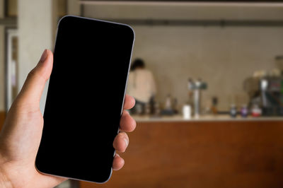 Close-up of hand holding smart phone