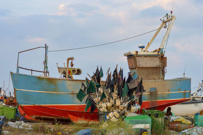 Abandoned fishing boat against sky