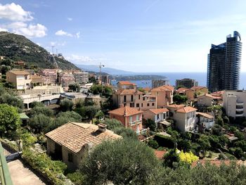 High angle view of buildings and trees against sky