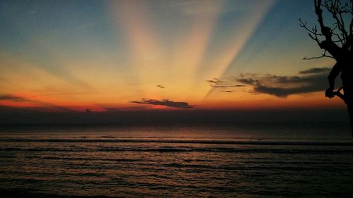 Scenic view of sea against romantic sky at sunset