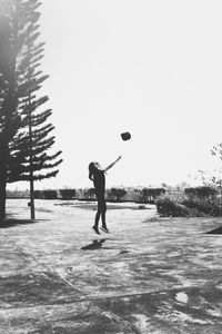 Man playing with ball against clear sky