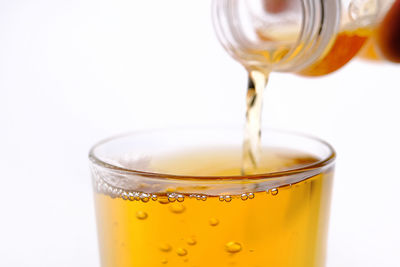 Close-up of drink in glass against white background