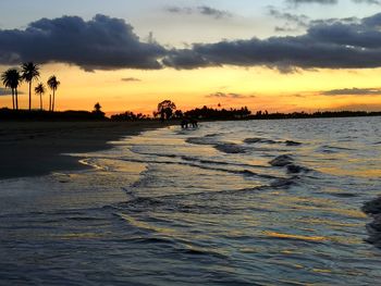 Scenic view of beach against sky during sunset