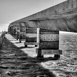 Built structure by sea against clear sky