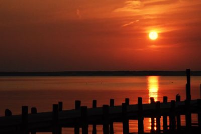 Scenic view of sea against orange sky