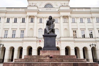 Low angle view of statue against historic building