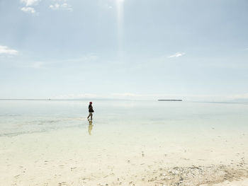 Full length of man on beach against sky