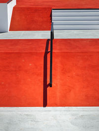 Close-up of red seat on concrete wall