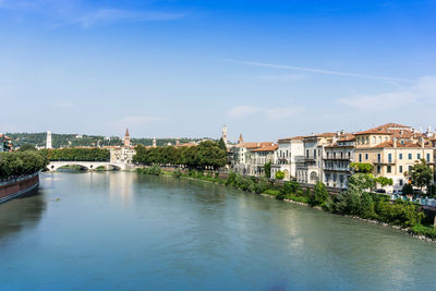 Adige river against sky in city