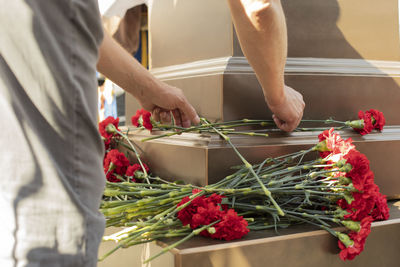 Midsection of woman holding red chili peppers in basket