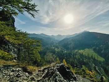 Scenic view of mountains against bright sun