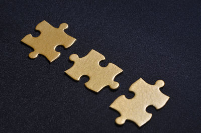 Close-up of jigsaw pieces over black background