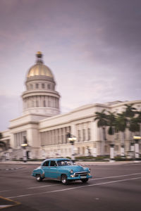 Cars on road against buildings in city