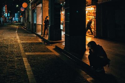 People walking on street at night