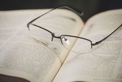 Close-up of eyeglasses on open book