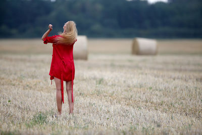 Full length of woman standing on field