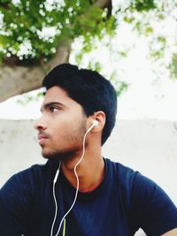 Young man listening to music on headphones