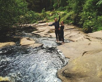 Full length of woman standing on rock