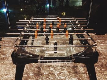 View of empty bench against illuminated lights at night