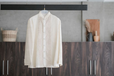 Close-up of clothes hanging against wall at home