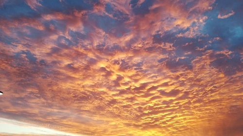 Low angle view of dramatic sky during sunset