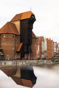 Ancient crane - zuraw old town in gdansk. the riverside on granary island reflection in moltawa