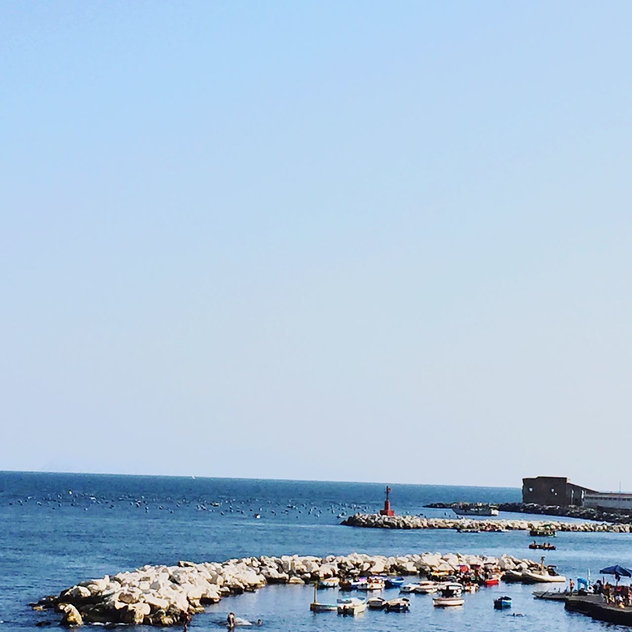 sea, nautical vessel, water, mode of transport, boat, horizon over water, scenics, nature, tranquility, blue, tranquil scene, beauty in nature, day, outdoors, sky, idyllic, ocean, no people, tourism