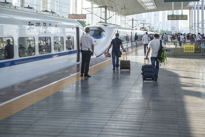 People standing on railroad station platform