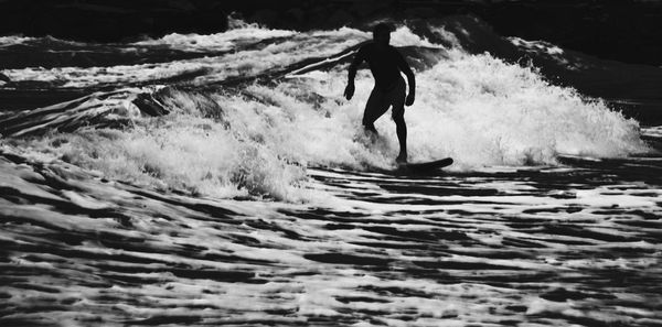 People surfing in sea