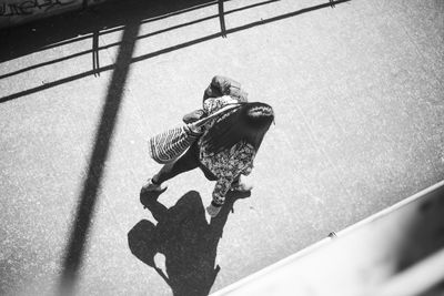 High angle view of man holding umbrella on street