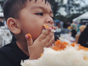 Close-up portrait of boy eating food