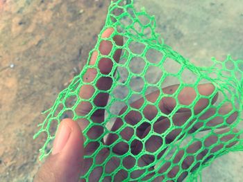 Cropped hand of person holding netting