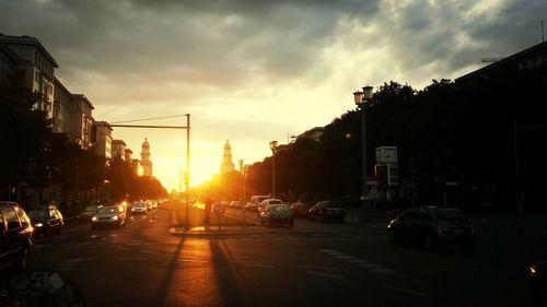 Traffic on road at sunset