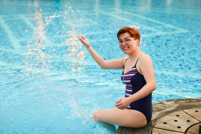 Portrait of young woman in swimming pool